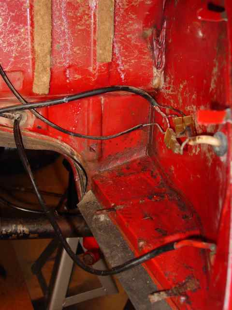 Right side of the engine compartment. This is what you will find if you remove the fiberboard piece.